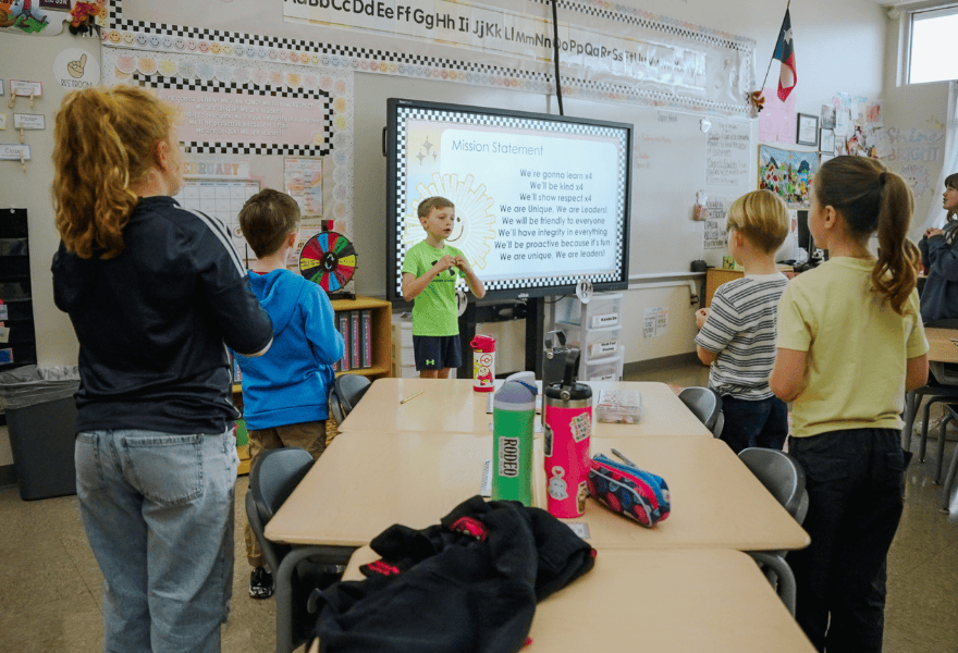 Elementary students engaged in a classroom presentation, representing education initiatives and youth leadership development programs in Utah communities