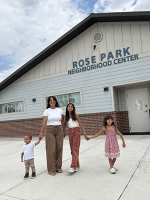 Family walking outside Rose Park Neighborhood Center in Utah, highlighting community support services and neighborhood-based programs for families